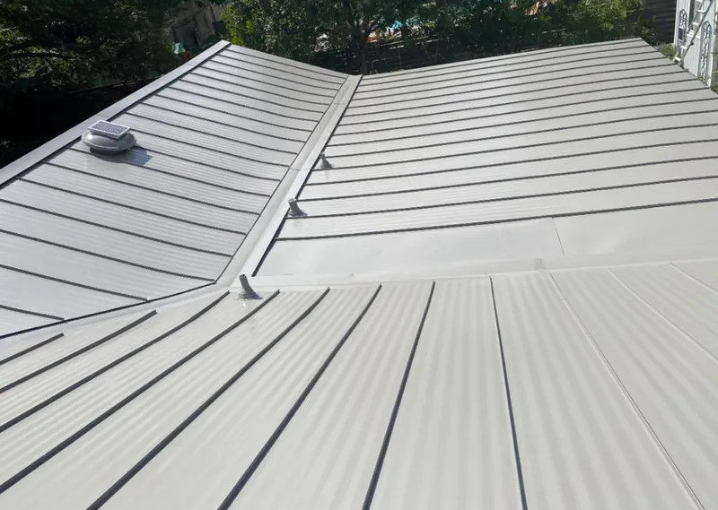Solar attic fan installed on a metal roof for Roof Ventilation in Kensington